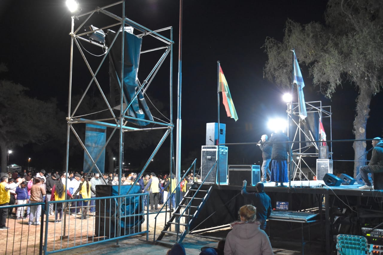 Estructura y torre del escenario iluminadas durante la noche de campaña.