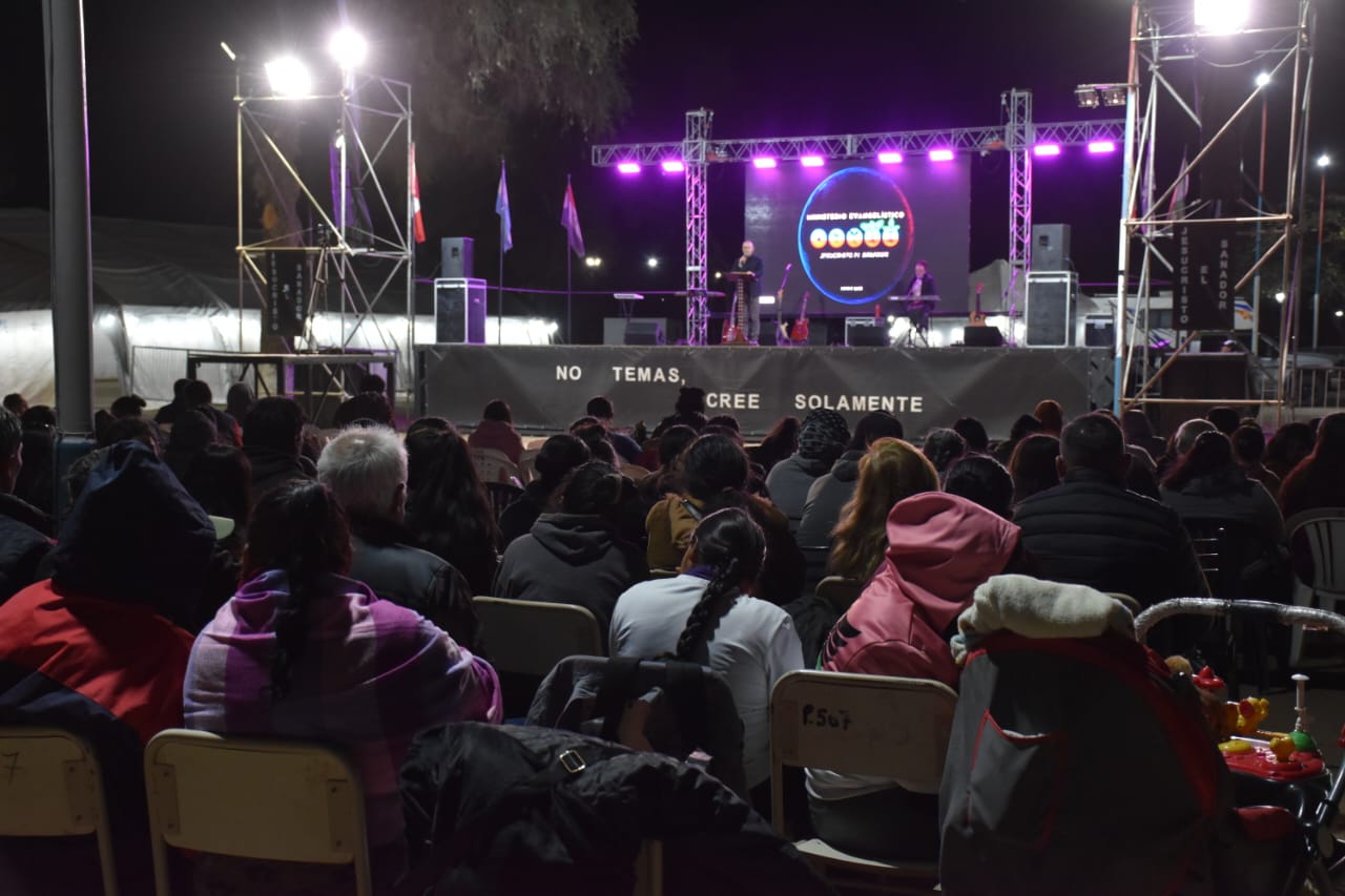 Público reunido frente al escenario iluminado durante la campaña.